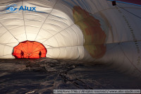The air ballon envelope is held on the ground by the crew