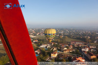 View over the city from the air balloon (the red stroke is a part of the basket frame)