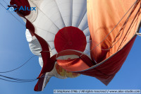 The envelope of the air balloon is being emptied of some of its air